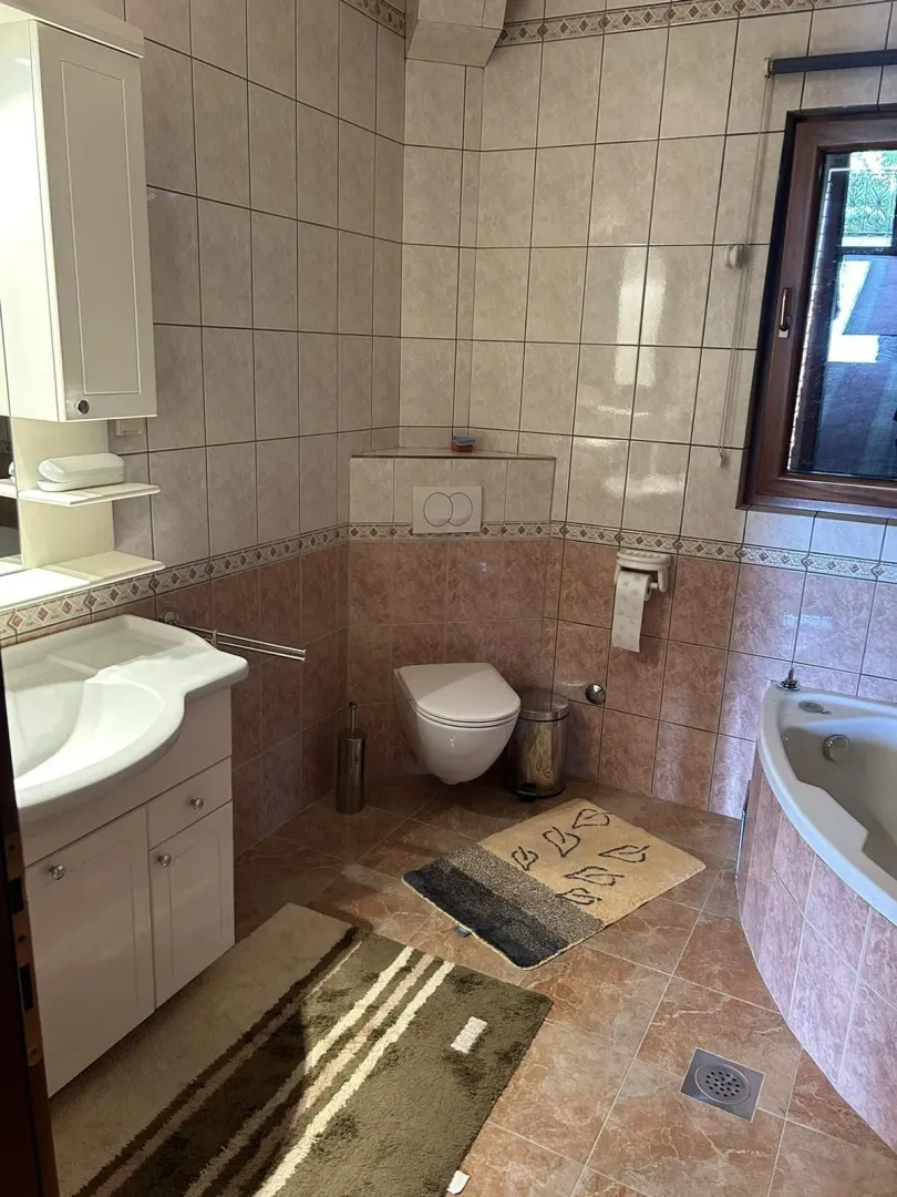 Bright bathroom with a bathtub and toilet.