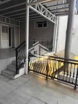 Covered terrace with a metal railing and stairs in front of the entrance. - image 27