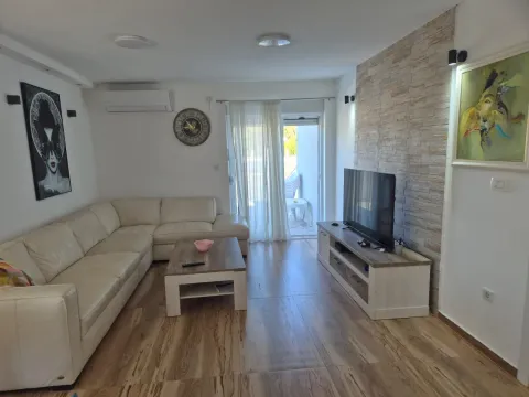 Living room with a sectional sofa, TV unit, and access to the terrace. - image 14