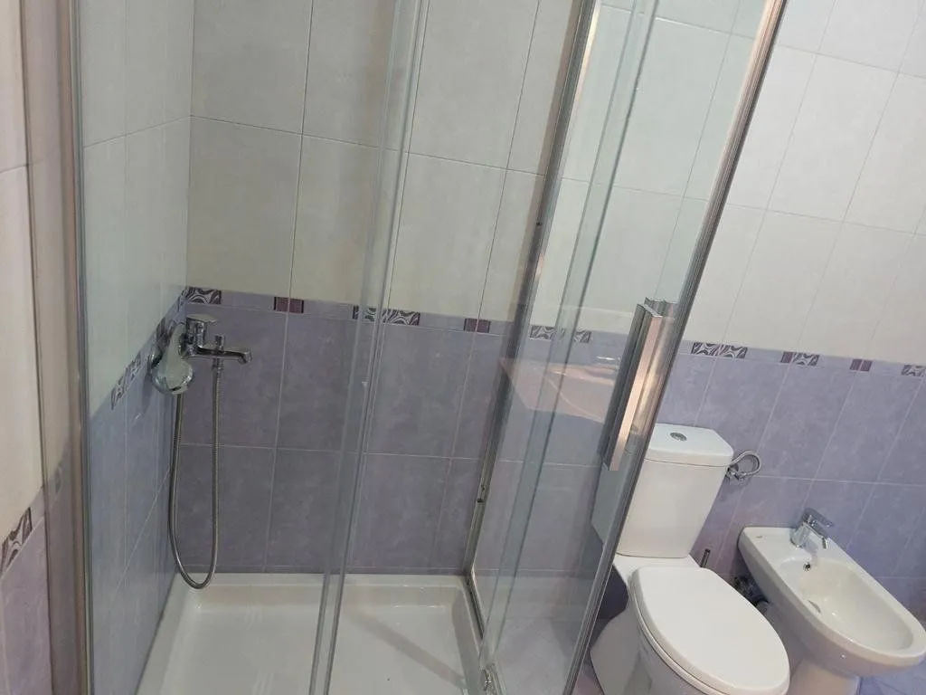 Bathroom with a shower cabin, toilet and bidet.