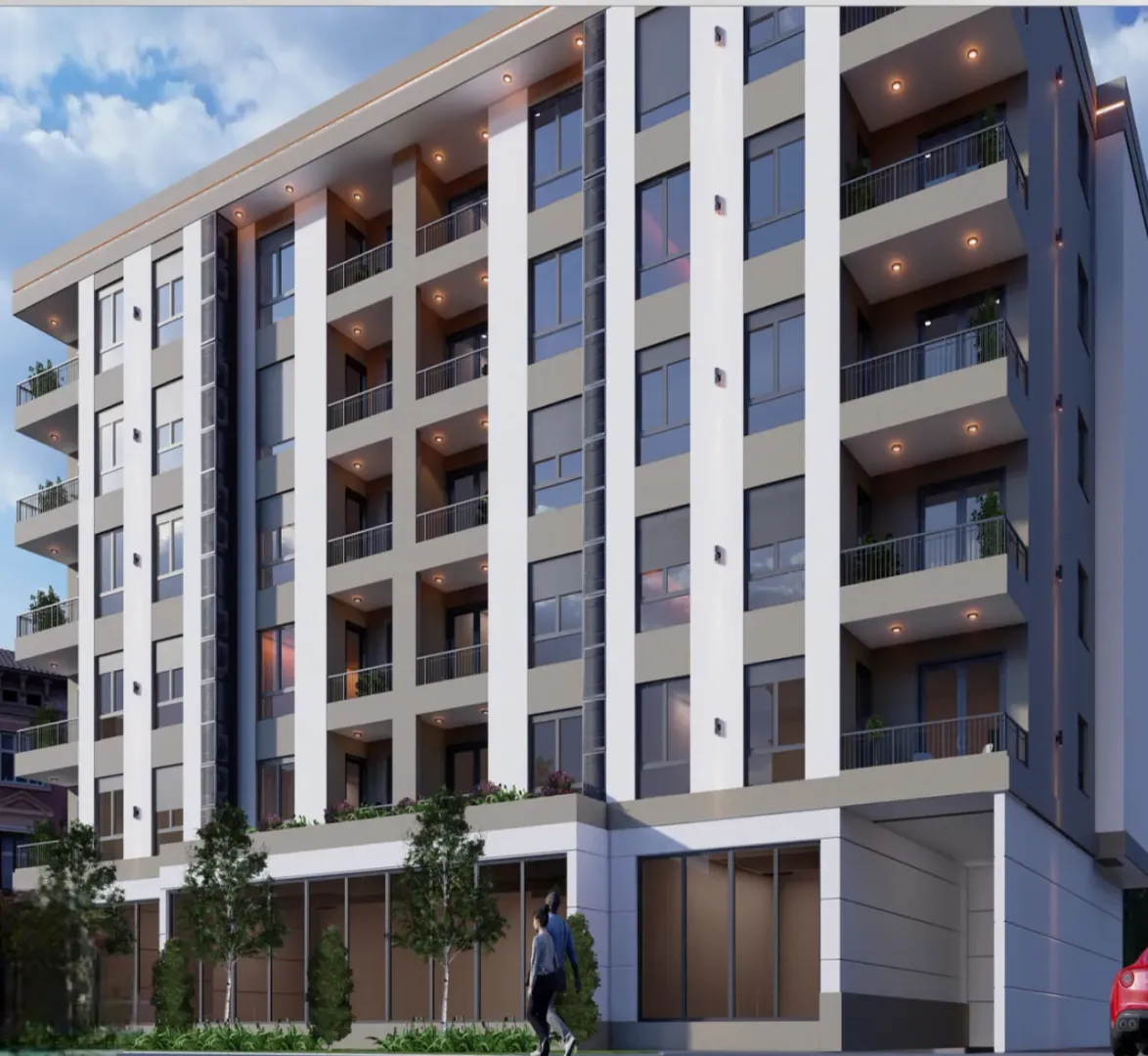 Exterior of a modern residential building with balconies and a landscaped ground floor.