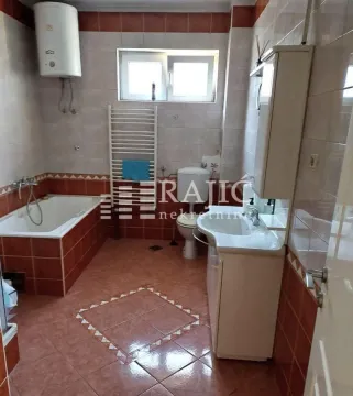 Bathroom with a bathtub, sink, and toilet. - image 16