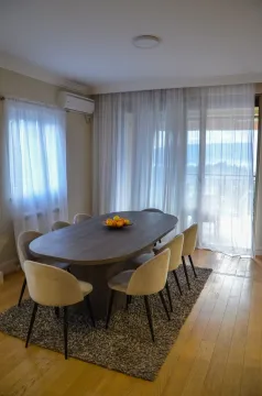 Dining area with a large table, chairs, and access to the terrace. - image 6