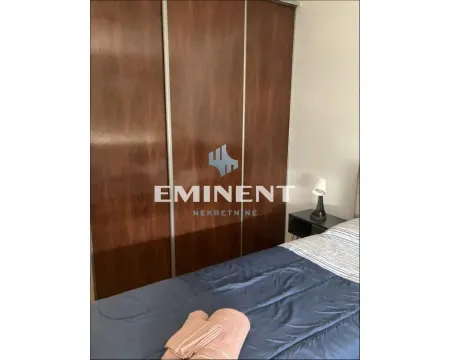 Bedroom with a large wooden wardrobe and a bed. - image 9