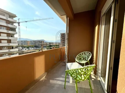 Furnished balcony with seating set and city view. - image 8