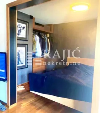 Bedroom with a double bed, wardrobe, and wooden floor. - image 6