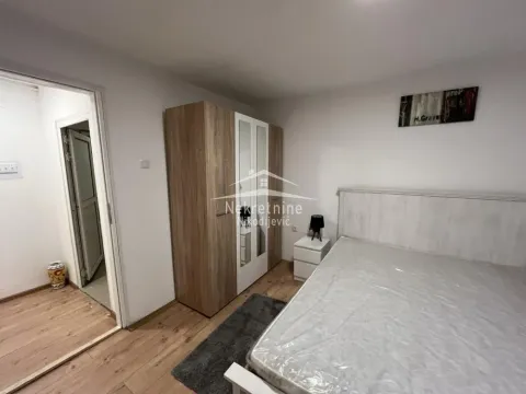Furnished bedroom with a double bed, wardrobe, and a nightstand. - image 5
