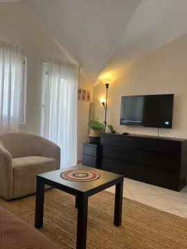 Living room with furniture, TV, and coffee table. - image 3