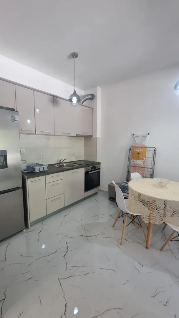 Small kitchen with a dining table and white cabinetry.