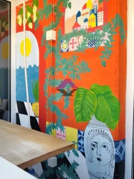 Terrace with a painted wall and a wooden table. - image 6