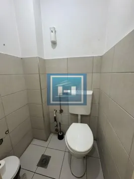 Small bathroom with a toilet and ceramic tiles. - image 9