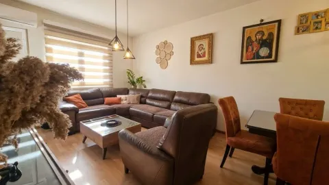 Living room with a sectional sofa, armchair, and dining table. - image 4