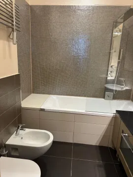 Modern bathroom with a bathtub and bidet. - image 13