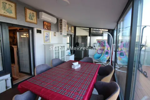 Enclosed terrace with a dining table and chairs. - image 17
