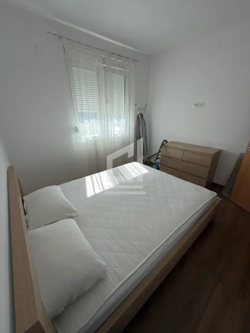 Bedroom with a double bed, chest of drawers, and a window.