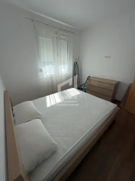 Bedroom with a double bed, chest of drawers, and a window. - image 6