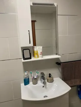 Small bathroom with a sink and a mirrored cabinet. - image 13