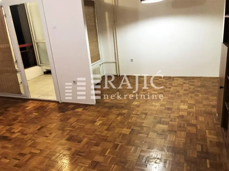 Empty room with parquet flooring and access to the terrace.