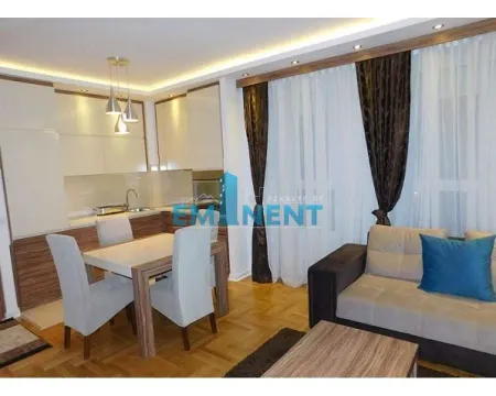 Living room with dining area and open-plan kitchen. - image 11