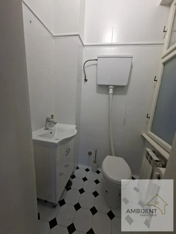 Small bathroom with white tiles and sanitary ware.