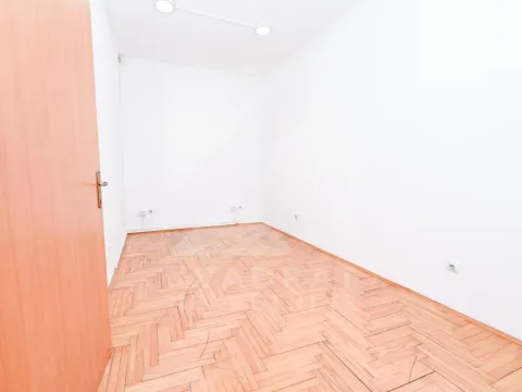 Empty room with white walls and wooden parquet flooring. - image 18