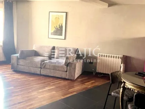 Living room with a sofa and dining table. - image 4