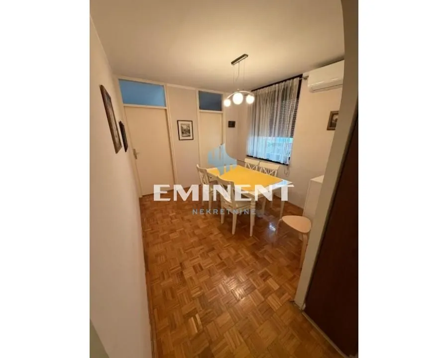 Dining area with a dining table and wooden flooring.