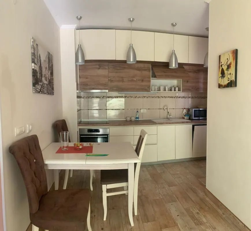 Kitchen with dining area and wooden elements.