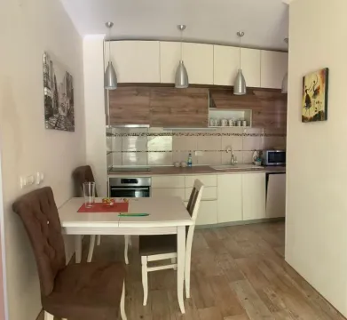 Kitchen with dining area and wooden elements. - image 2