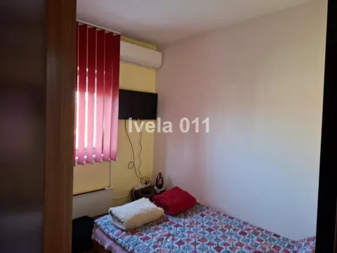 Manja spavaća soba sa krevetom, televizorom na zidu i klima uređajem. - image 8