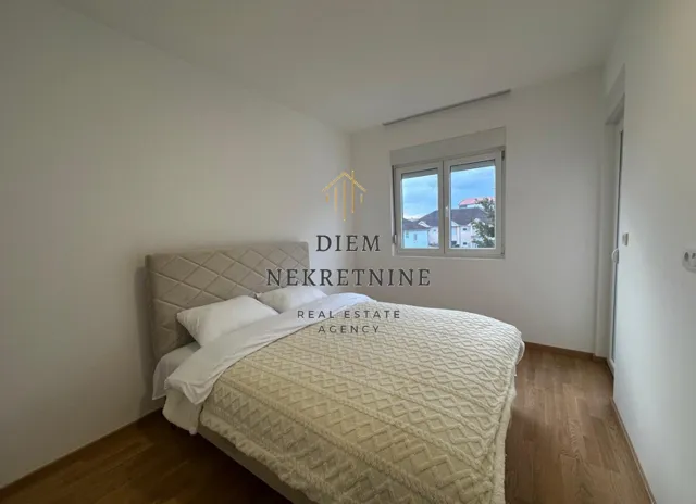 Bright and tidy bedroom with a double bed.