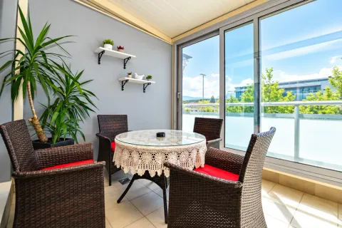 Enclosed terrace with seating furniture and a view of the surroundings. - image 9