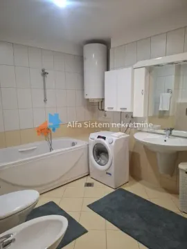 Bathroom equipped with a bathtub, washbasin, washing machine and sanitary fixtures. - image 9
