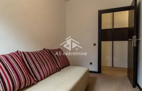 Smaller bedroom with a bed and a built-in wardrobe in the background. - image 9