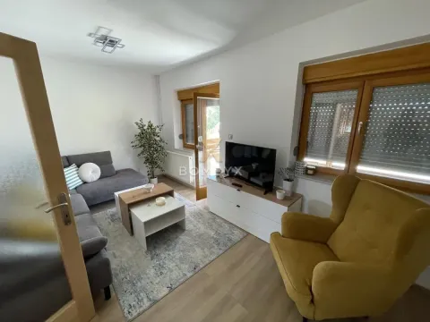Dnevna soba sa garniturom, foteljom, televizorom i izlazom na terasu. - image 42
