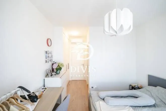 View of the bedroom with a bed and a desk.