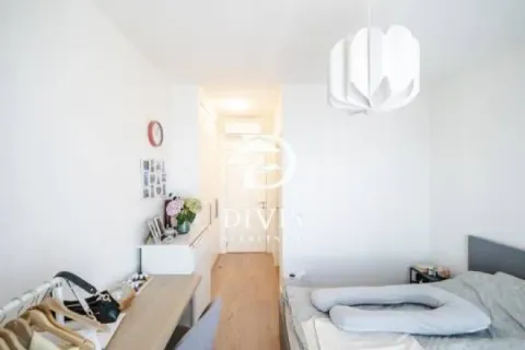 View of the bedroom with a bed and a desk. - image 9