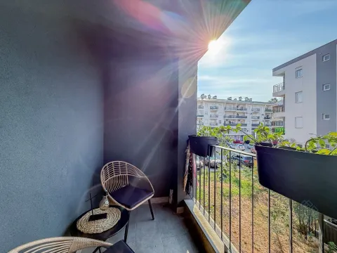 Furnished balcony with seating area and view of the neighborhood. - image 12