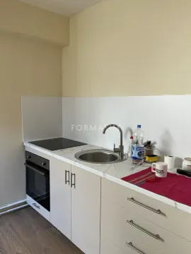 Small kitchen with a sink, oven, and built-in hob. - image 13