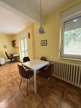Living room with a dining table and a work corner. - image 3