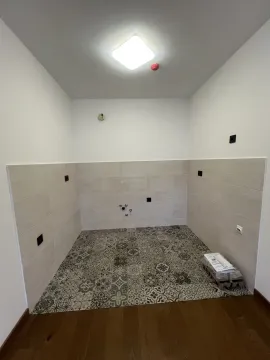 An unfinished empty space featuring decorative floor tiles. - image 8