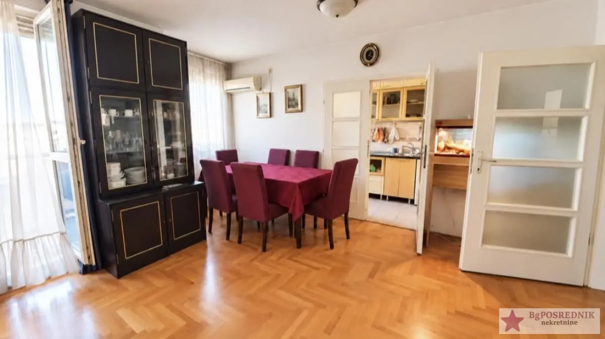 Dining room with a wooden table, chairs, and a dark cabinet.