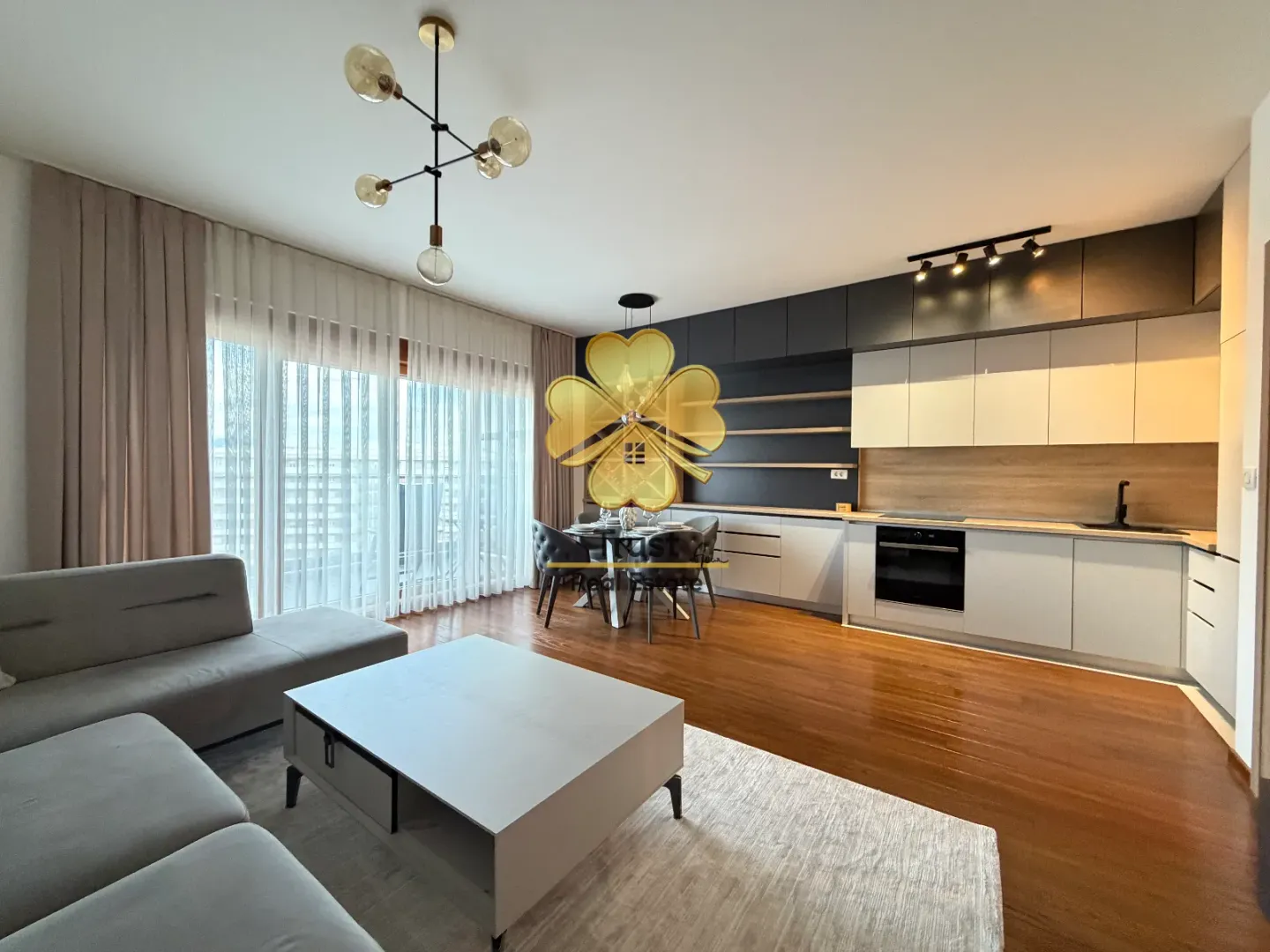 Modern living room with kitchen and dining area.