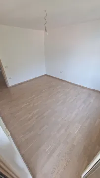 Empty room with white walls and wooden flooring. - image 4
