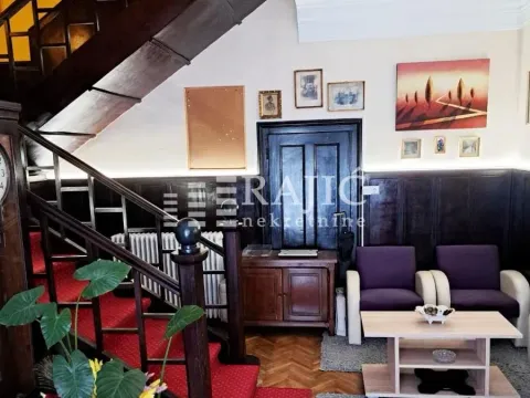 Living room with seating furniture, staircase, and wooden wall paneling. - image 13