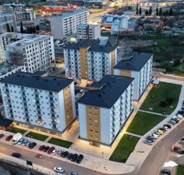 Aerial view of a residential complex with landscaped courtyard and parking. - image 9