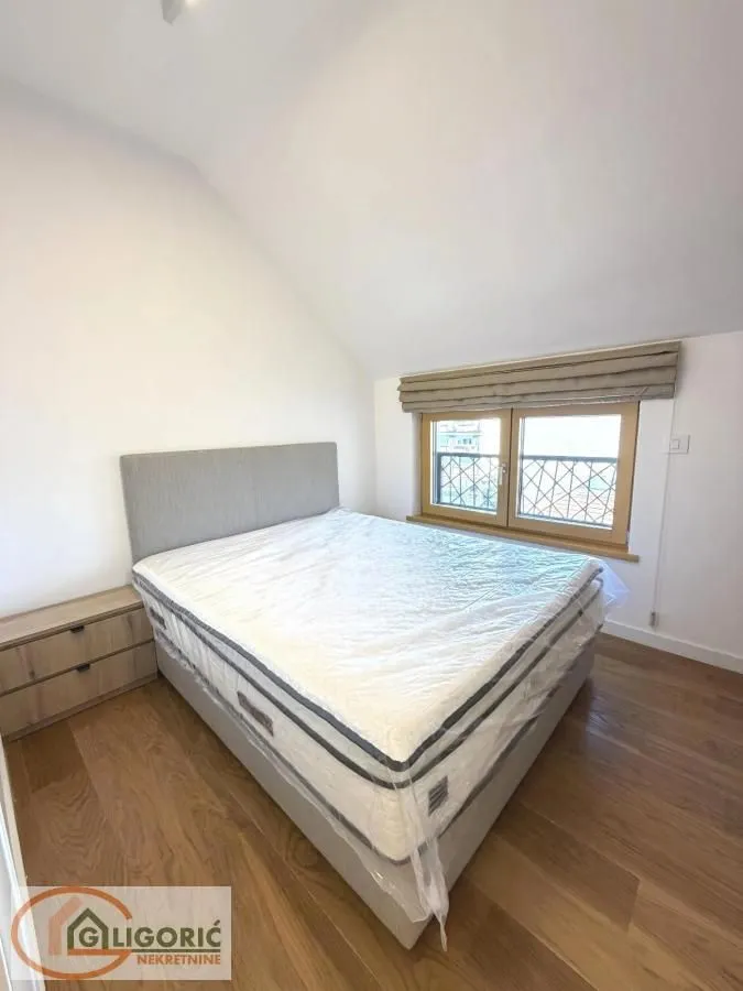Bedroom with a double bed and a sloping window.