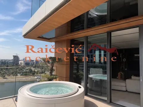 Spacious terrace with a hot tub and views of the city and river. - image 5