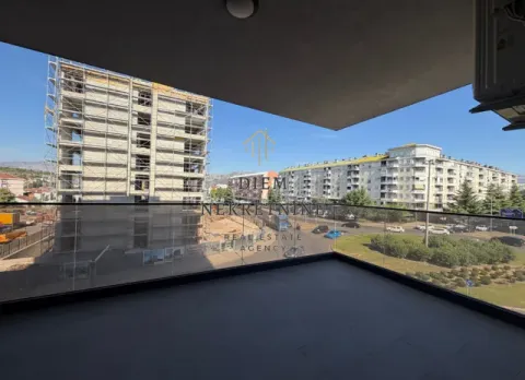 View from the balcony overlooking the city and surrounding buildings under construction. - image 2