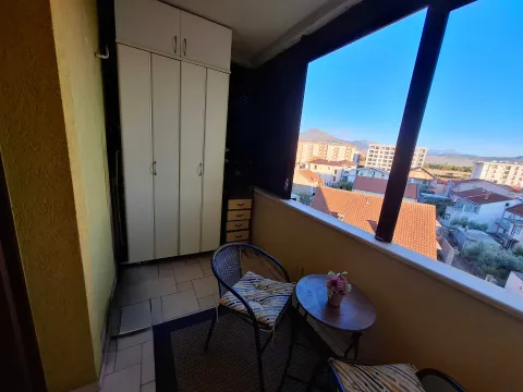 Enclosed balcony with built-in wardrobe and city view. - image 6
